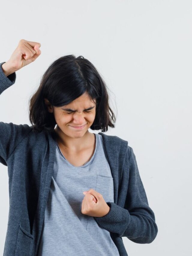 young-girl-clenching-fists-while-squeezing-eyes-light-gray-t-shirt-dark-grey-zip-front-hoodie-looking-annoyed_176474-18764