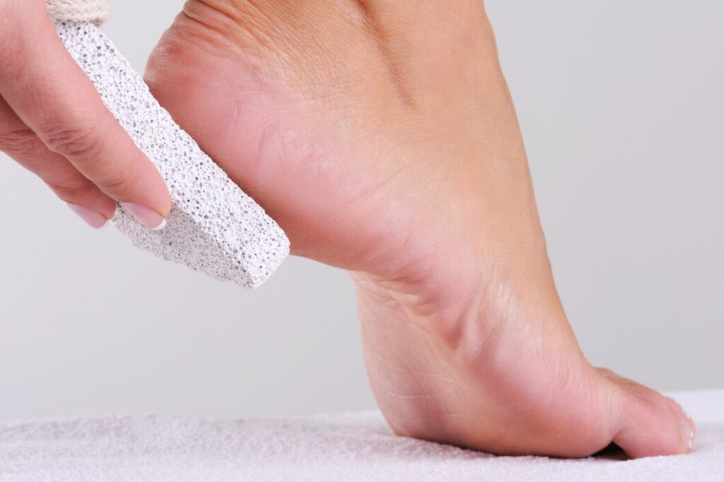 young woman scrubbing her foot by pumice beauty salon 186202 749 young-woman-scrubbing-her-foot-by-pumice-beauty-salon_186202-749