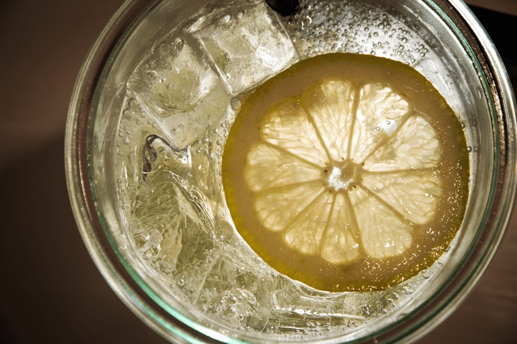 image 34 A GLASS OF WATER CONTAINING ICE AND LEMON SLICE